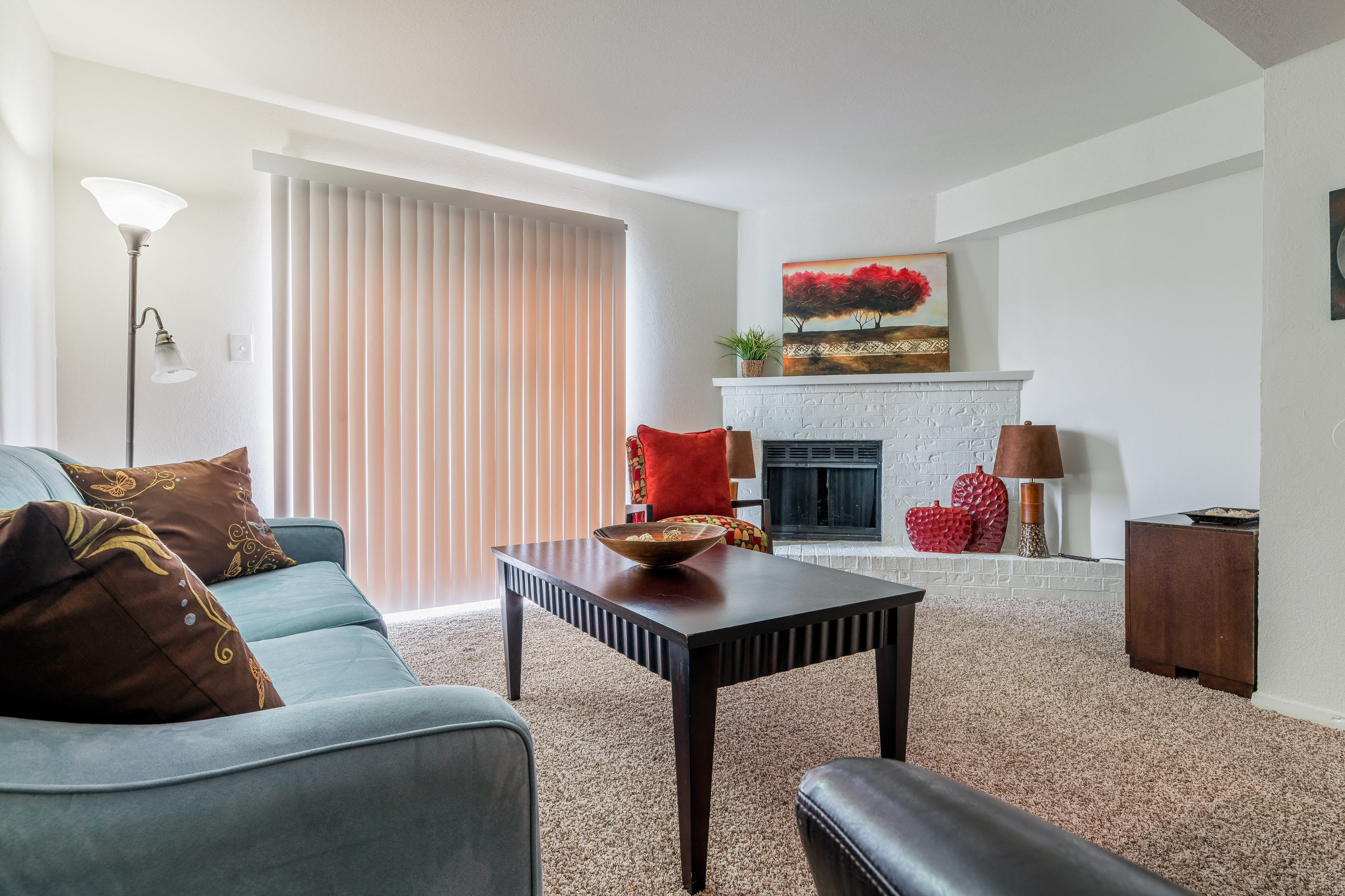 a living room with a couch and a coffee table and a fireplace
